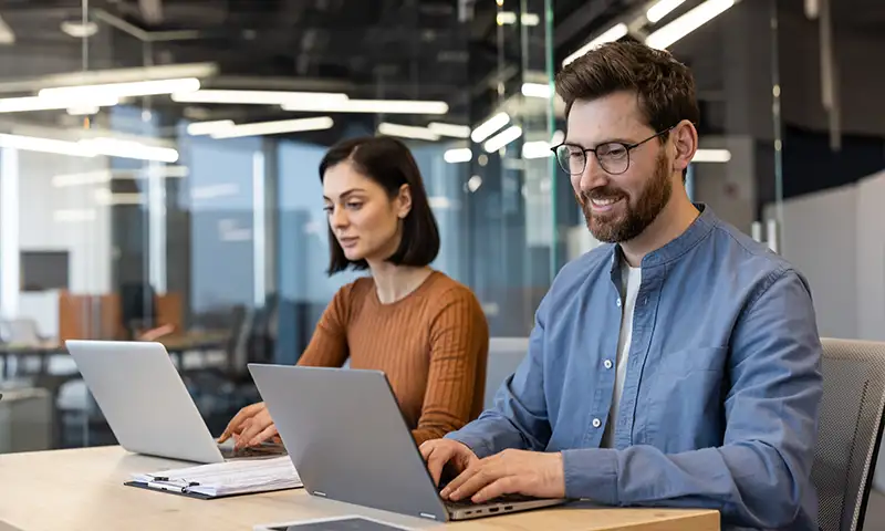 team members working on well maintained laptops