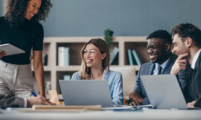 team members working on laptop computers