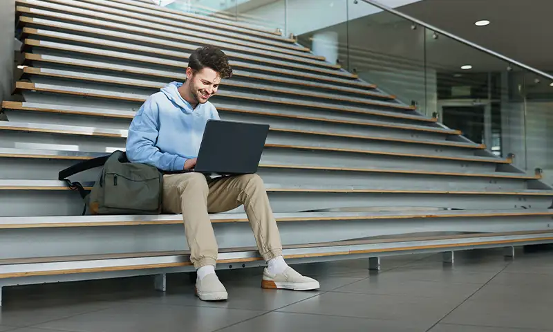 man working on his laptop using campus wide network wifi