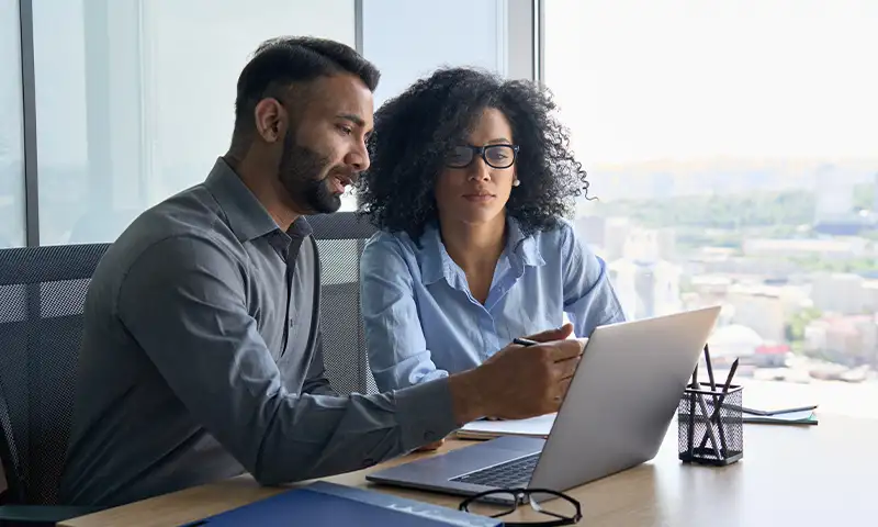 A cloud professional reviewing potential cost savings with a client