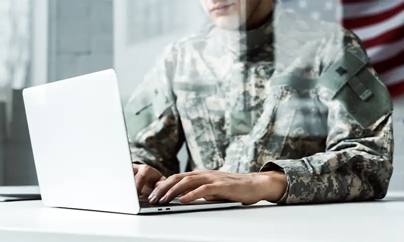 military personnel on a laptop