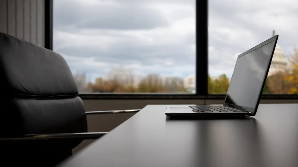 Laptop on a desk in Washington, DC with the US Capital building in the background