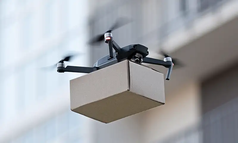 A drone delivering a package utilizing SkyWave connectivity