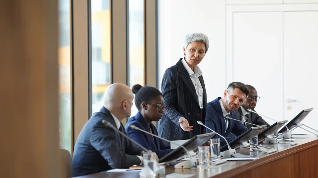 local government officials meeting with modern technology devices