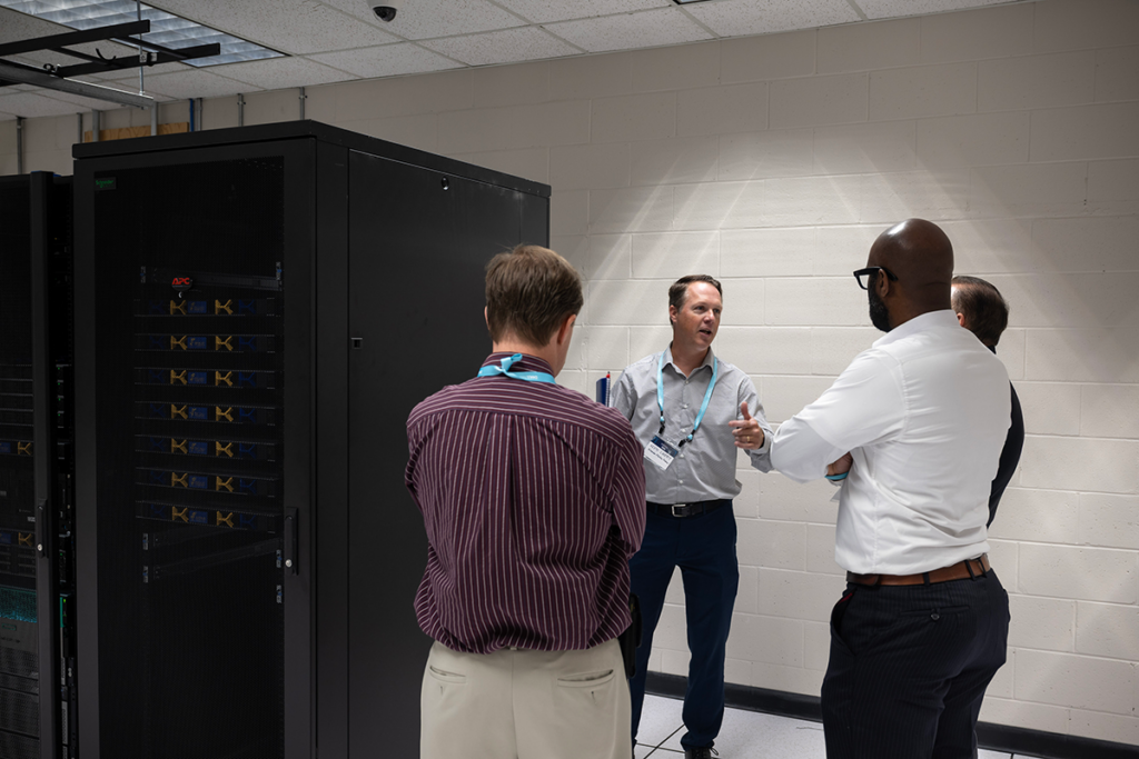 A technology specialist showcasing modern infrastructure to attendees