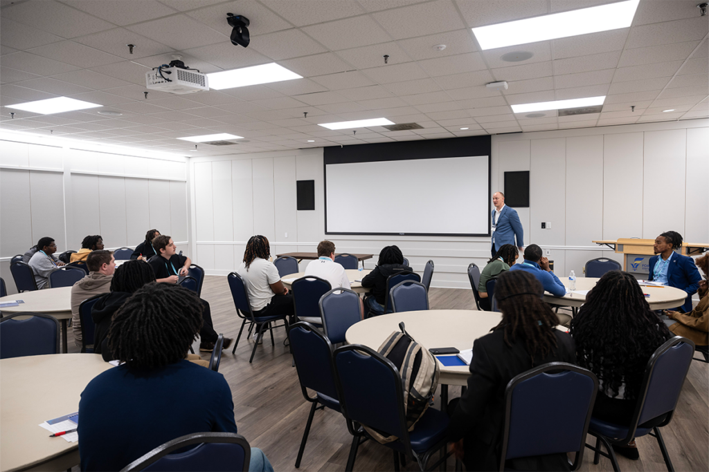 A TIPE speaker hosting a presentation with attendees